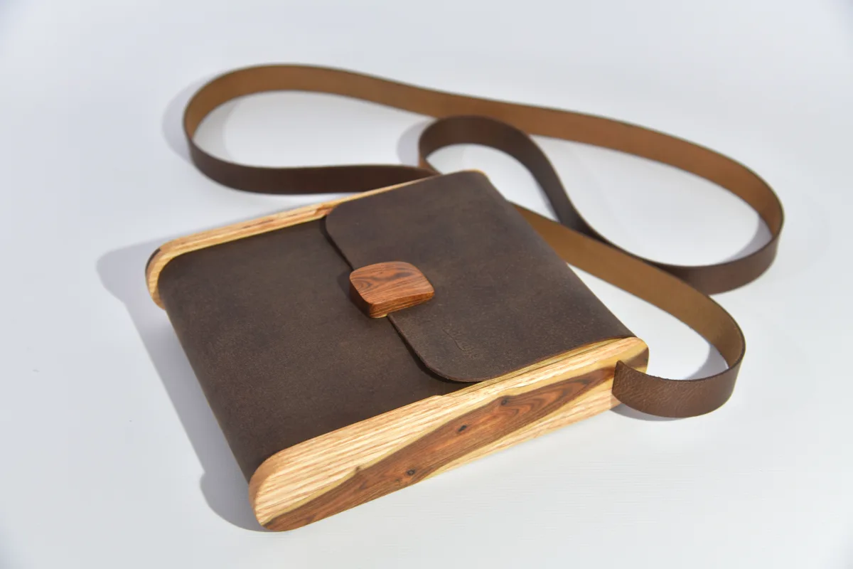 Bernd XS from smoothed, antique water buffalo full-grain leather in dark brwon with elaborate inlays and closure in Gorse wood from La Palma and ash wood